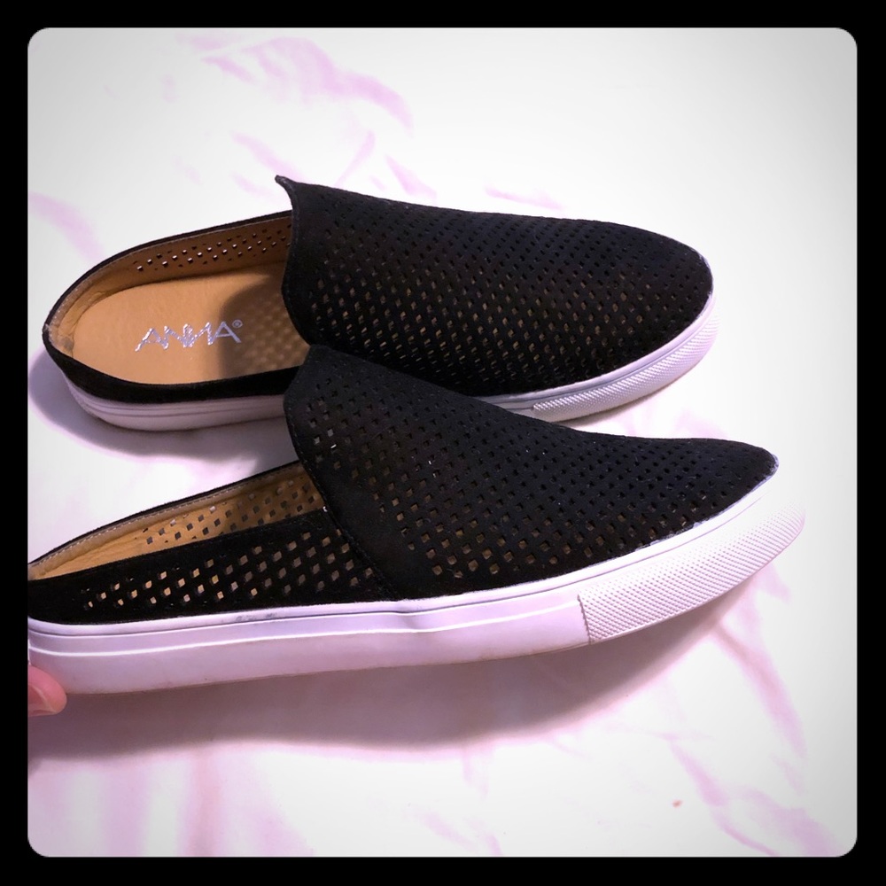 Flat, slip on black clogs.